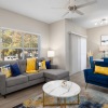 living area with a table, chair, and couch