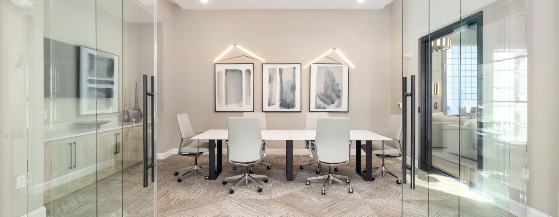 a room with a table chairs and a glass wall