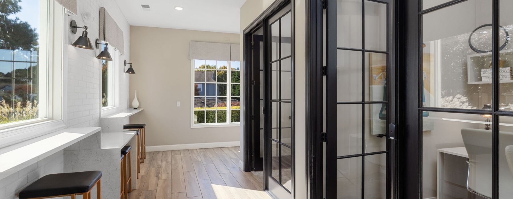 hallway with windows and private working rooms with desks and chairs