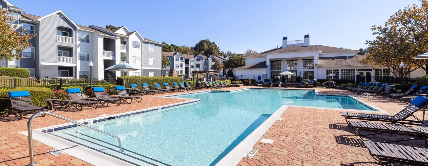 a swimming pool with chairs around it