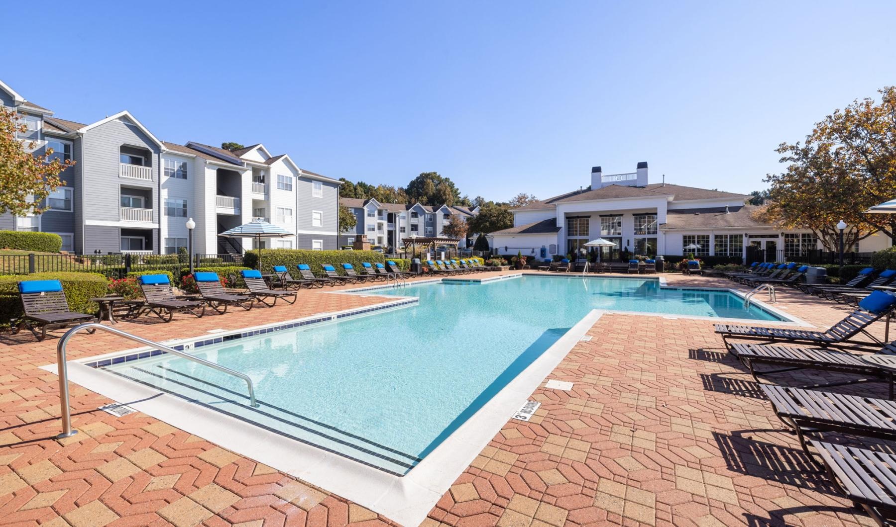 a swimming pool with chairs around it
