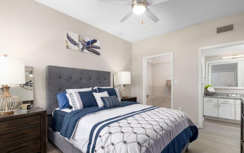 a bedroom with a bed and a lamp