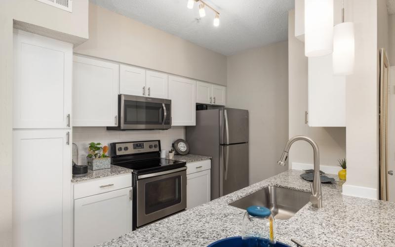 a kitchen with white cabinets