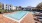 a swimming pool with chairs around it